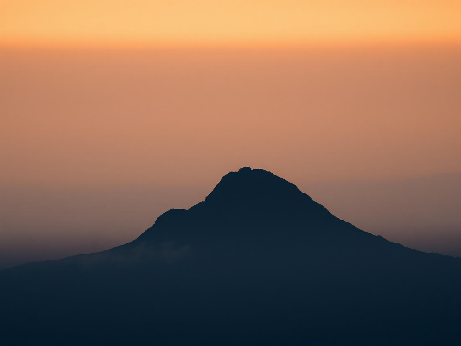 Silhouette of a mountain peak at dawn